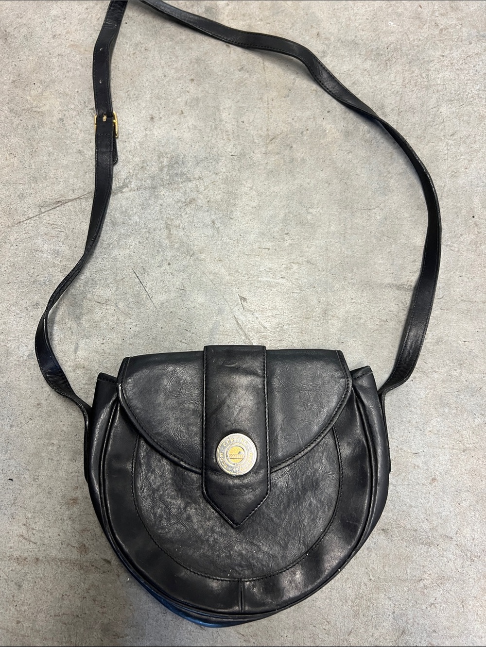 Black Leather Rounded Crossbody Bag with Gold Medallion